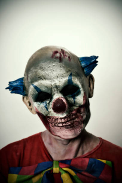 istock double exposure of a scary clown and a skull 866523128