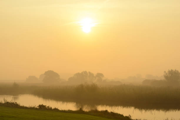 Sunrise over the river IJssel during a beautiful fall morning in the IJsseldelta region in Overijssel, The Netherlands.