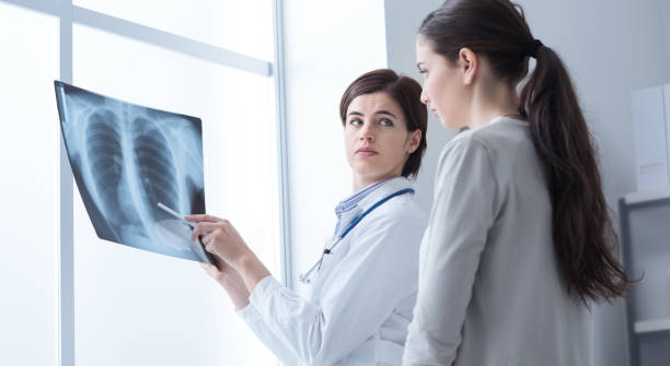 istock Doctor examining patient's x-ray 866523810