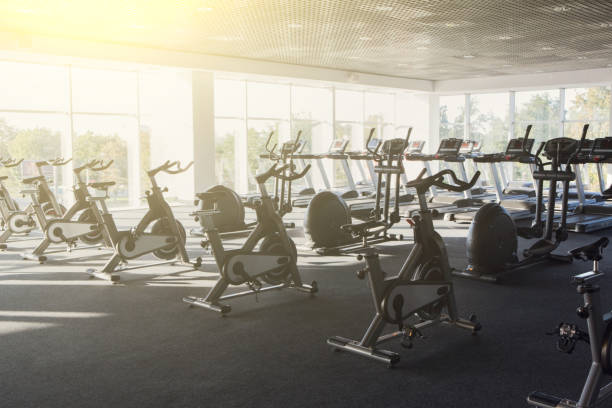istock Modern gym interior with equipment, fitness exercise bikes 866527580