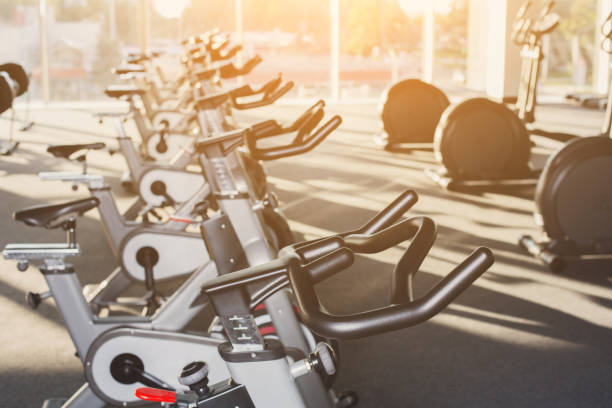 istock Modern gym interior with equipment, fitness exercise bikes 866527700