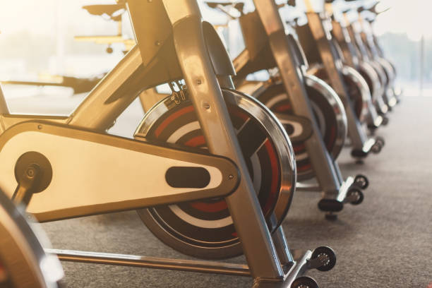 istock Modern gym interior with equipment, fitness exercise bikes 866527808