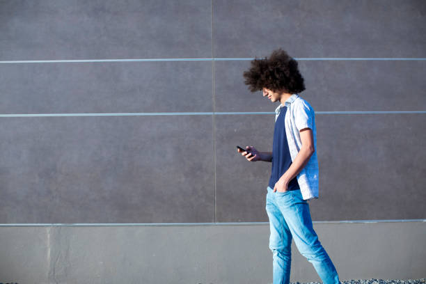 istock Young man using mobile phone on street 866530060