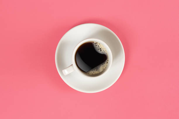 a cup of black coffee on pink background. view from above - coffee cup isolated cappuccino multi colored imagens e fotografias de stock