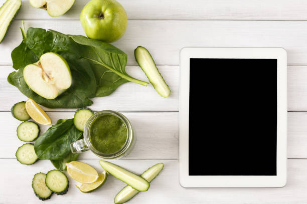istock Detox green smoothie ingredients, top view on white with tablet 866530220