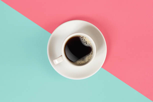 a cup of black coffee on blue and pink background. view from above - coffee cup isolated cappuccino multi colored imagens e fotografias de stock