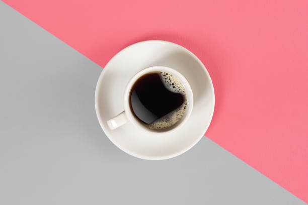 istock A cup of black coffee on gray and pink background. View from above 866530762