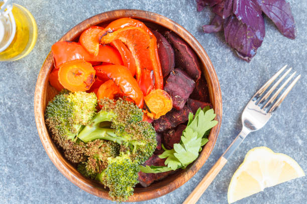 Vegetarian salad of baked vegetables in a wooden bowl