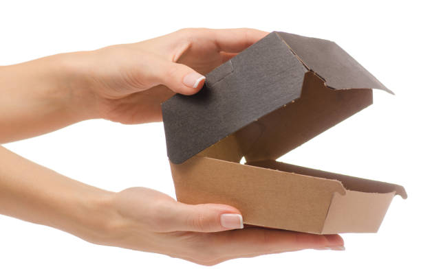 istock Box for a burger in a female hand 866534522