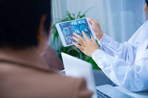 istock Doctor and patient discussing X-ray on digital tablet 866534946