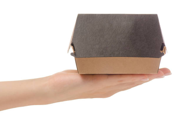 istock Box for a burger in a female hand 866534954