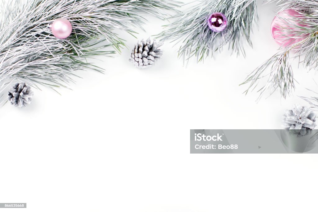 Christmas border with fir branches, presents, christmas ornaments on white background Christmas border with fir branches, presents, christmas ornaments on white background, copy space Purple Stock Photo