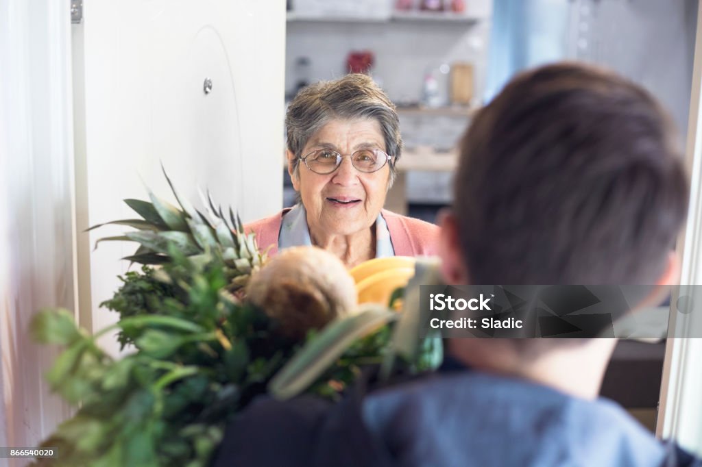 Home delivery Delivering Groceries To The Elderly Senior Adult Stock Photo