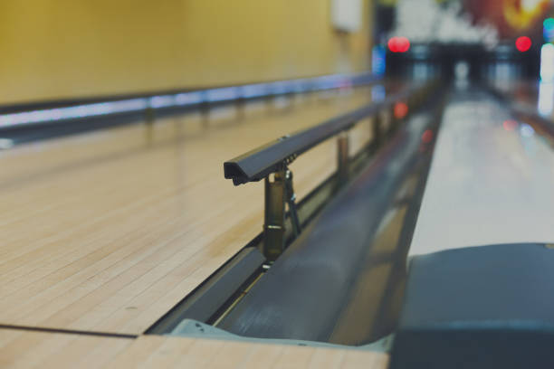 Bowling alley background, lane with bumper rails Bowling alley background. Lane with bumper rails closeup. Leisure activity club bowling alley wood stock pictures, royalty-free photos & images
