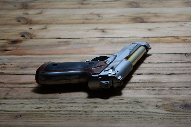 istock the old handgun  on  brown wooden table 866540912