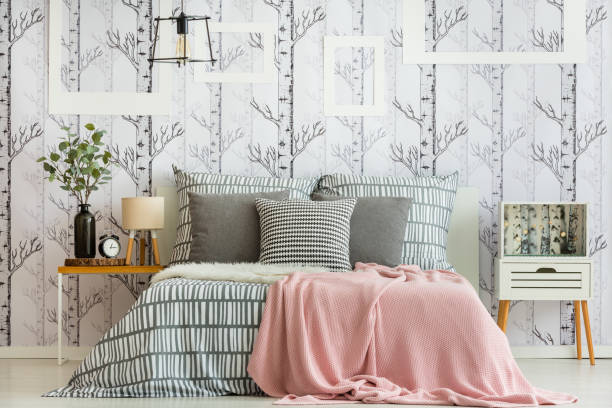 Feminine forest inspired bedroom Feminine bedroom interior with forest inspired decorations and geometric bedding bed decoration stock pictures, royalty-free photos & images