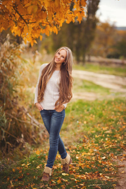 Beautiful smiling woman with luxurious hair. Autumn time. Fall season.