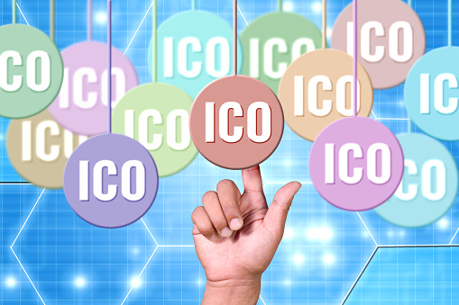 Finger pointing into chosing ico - initial coin offering