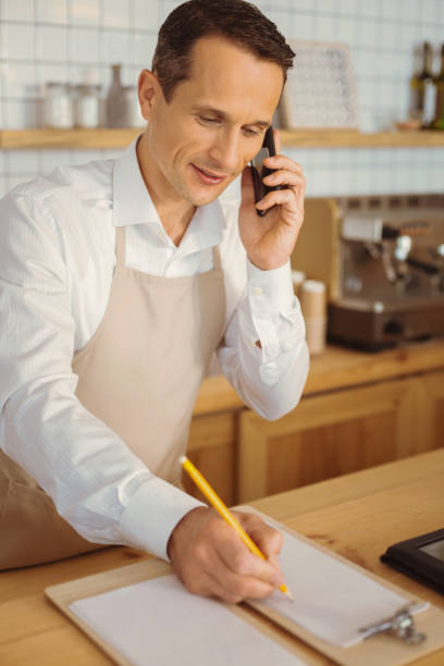 istock Delighted nice man talking on the phone 866556208