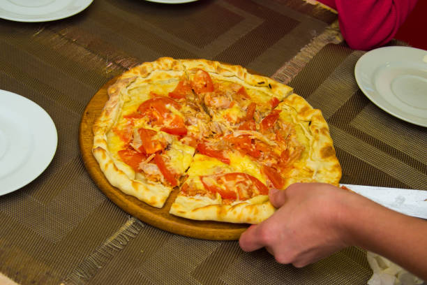 istock close the round pizza on a wooden backing 866556500