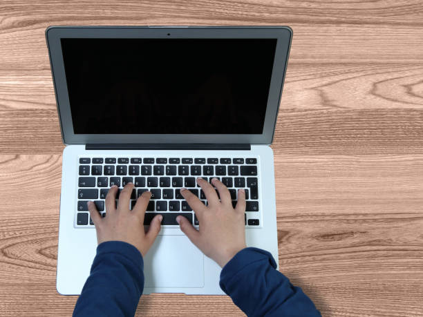 istock Laptop work wooden desk top view 866556968