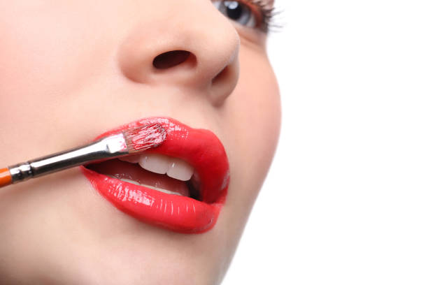 Make-up artist apply lipstick with brush, beauty