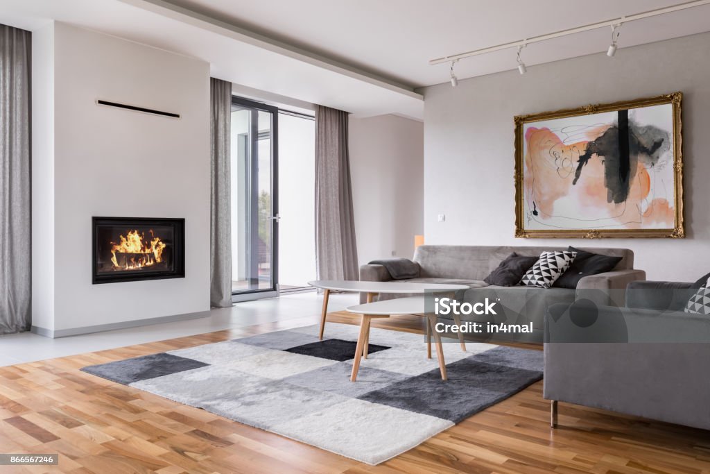 Living room with fireplace Modern living room with fireplace, sofa, balcony and pattern carpet Living Room Stock Photo