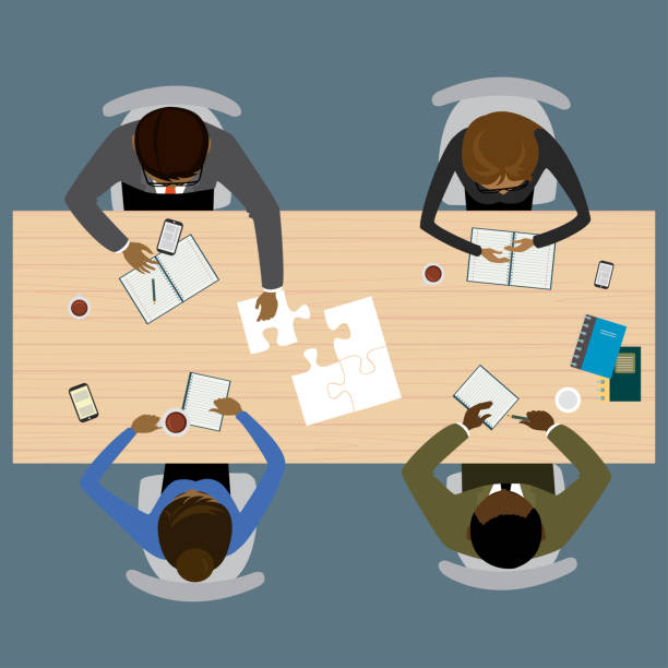 Teamwork, brainstorming, startup. Flat vector illustration Four people different races sitting and working together at the round table. Global Teamwork, brainstorming. Flat vector illustration four people office stock illustrations