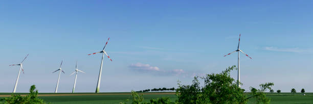 istock Panoramic image of wind generators producing alternative energy. 866570994