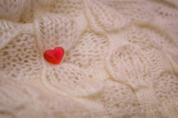 istock Red heart on a knitted white fabric background 866578978