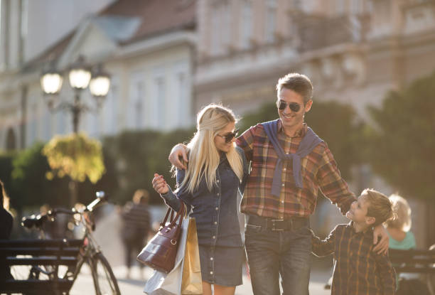 istock Little boy with his parents enjoying shopping 866579038