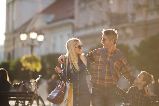 istock Little boy with his parents enjoying shopping 866579320