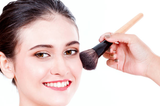 istock Stylist applying blusher to the beautiful woman 866583572