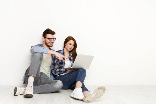 istock Casual couple working with laptop, studio shot 866583614