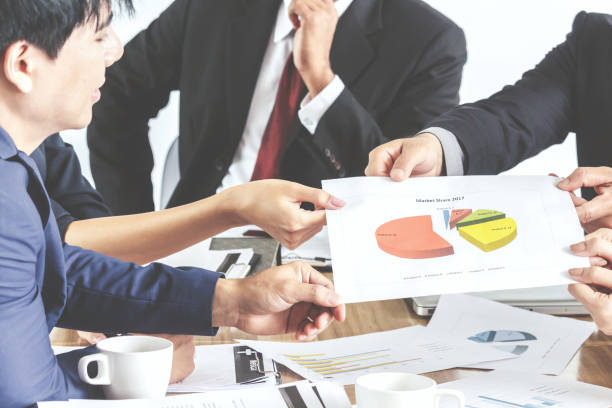 istock Business people's hands pointing at business document 866585012