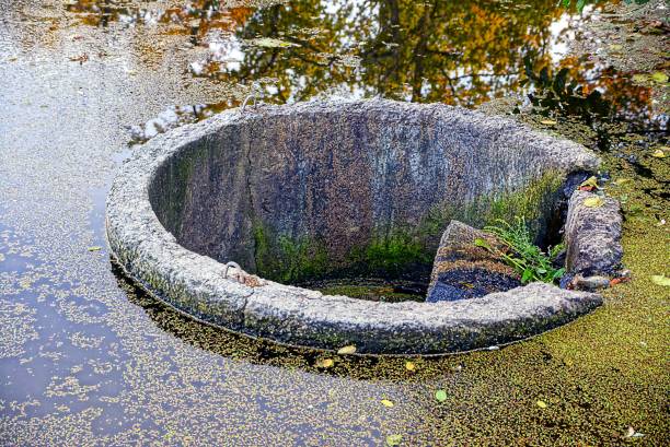 istock Gray round concrete dam on the lake 866585412