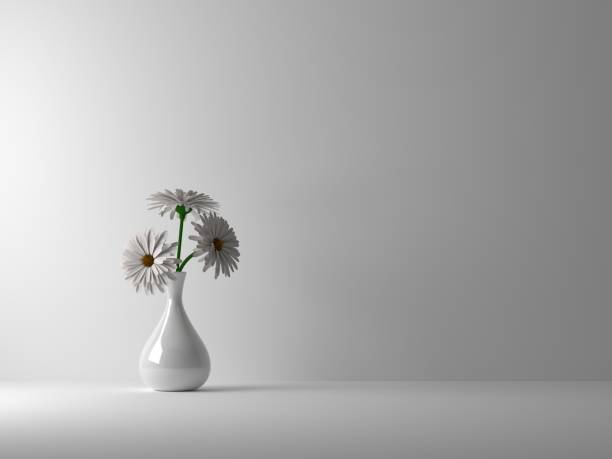 Beautiful chamomile flowers in vase on wooden table near grey wall
