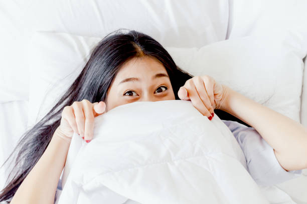 istock Pretty woman in bed under the blanket 866588732
