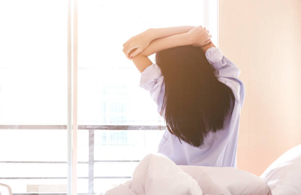 istock Woman stretching in bed after wake up 866588764