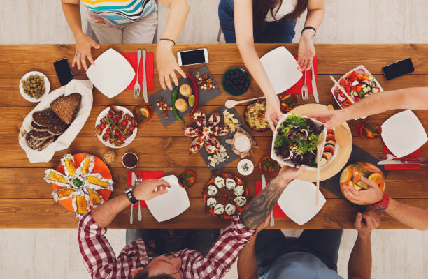 istock People eat healthy meals at served table dinner party 866588924