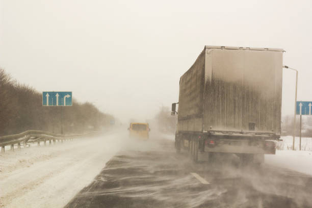 istock Snowstorm on track with cars riding 866589158
