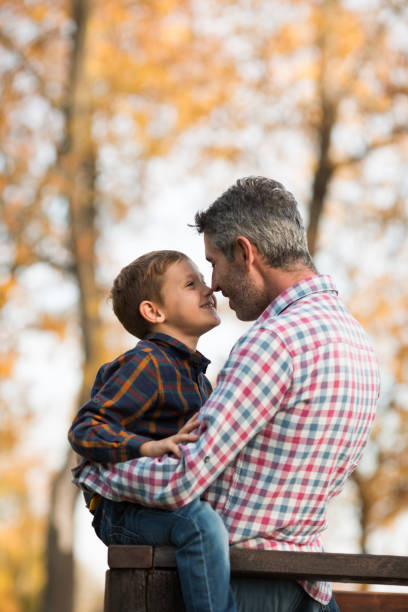 istock Father with his son in autumn forest. 866596278