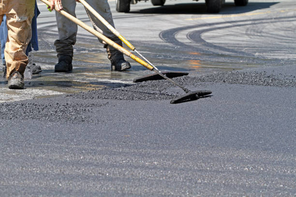 istock Raking Hot Asphalt On A Road Repair Site 866599146