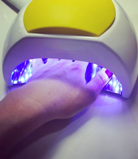 istock Manicure process - hand in nail dryer 866599542