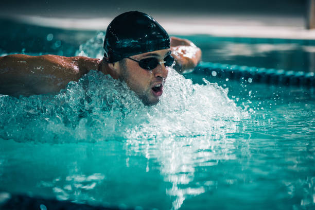 Front view of senior man at butterfly stroke, selective focus