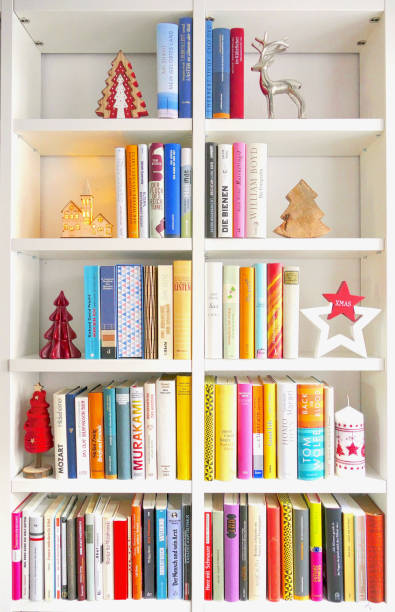 Letter L in the form of shelves with books in the room near wall, 3D rendering