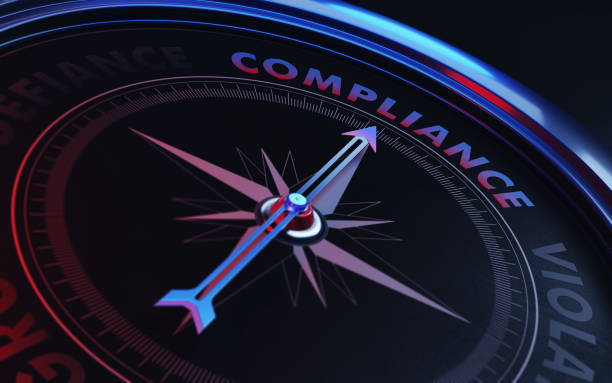 Compliance Concept: Arrow of A Compass Compliance Text Arrow of a compass is pointing compliance text on the compass. Arrow, compliance text and the frame of compass are metallic blue in color. Red light illuminating compass is creating a sense of tension. Black backgound. Horizontal composition with copy space. Compliance concept. conformity stock pictures, royalty-free photos & images