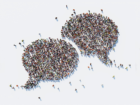 Human crowd forming a big speech bubble on white background. Horizontal composition with copy space. Clipping path is included. Communication And Social Media Concept