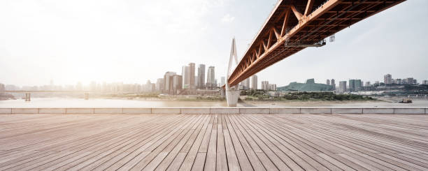 istock empty wooden floor with modern bridge and buildings 866608462