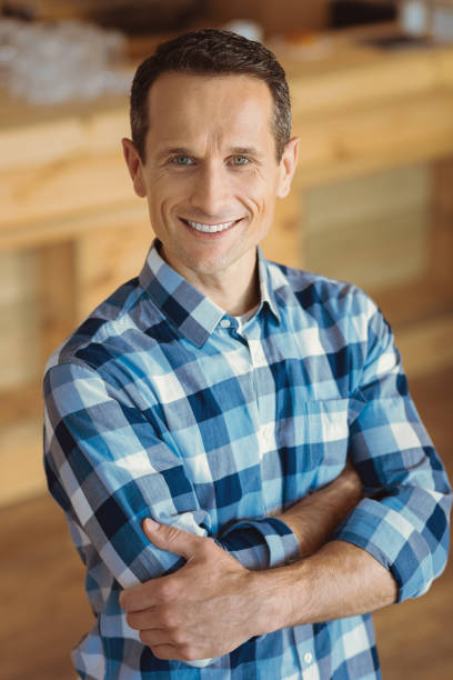 istock Pleasant cheerful man standing cross handed 866612550